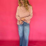 Close-up of the mock neckline and yarn-dyed horizontal stripe knit on the oversized long sleeve tee