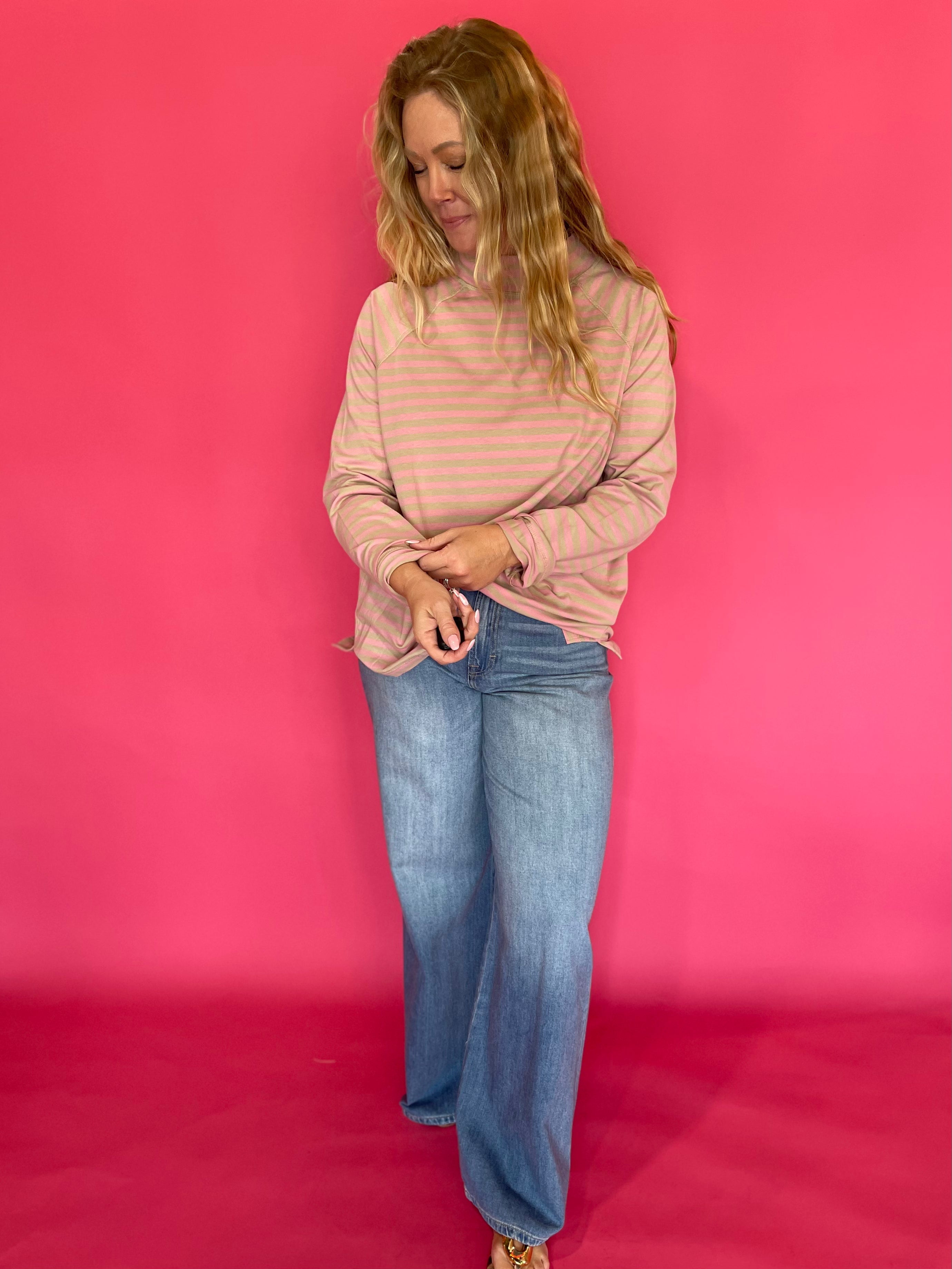 Close-up of the mock neckline and yarn-dyed horizontal stripe knit on the oversized long sleeve tee