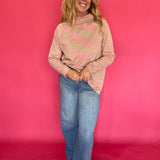 Side view showing the relaxed oversized drape and long raglan sleeves of the striped mock neck tee