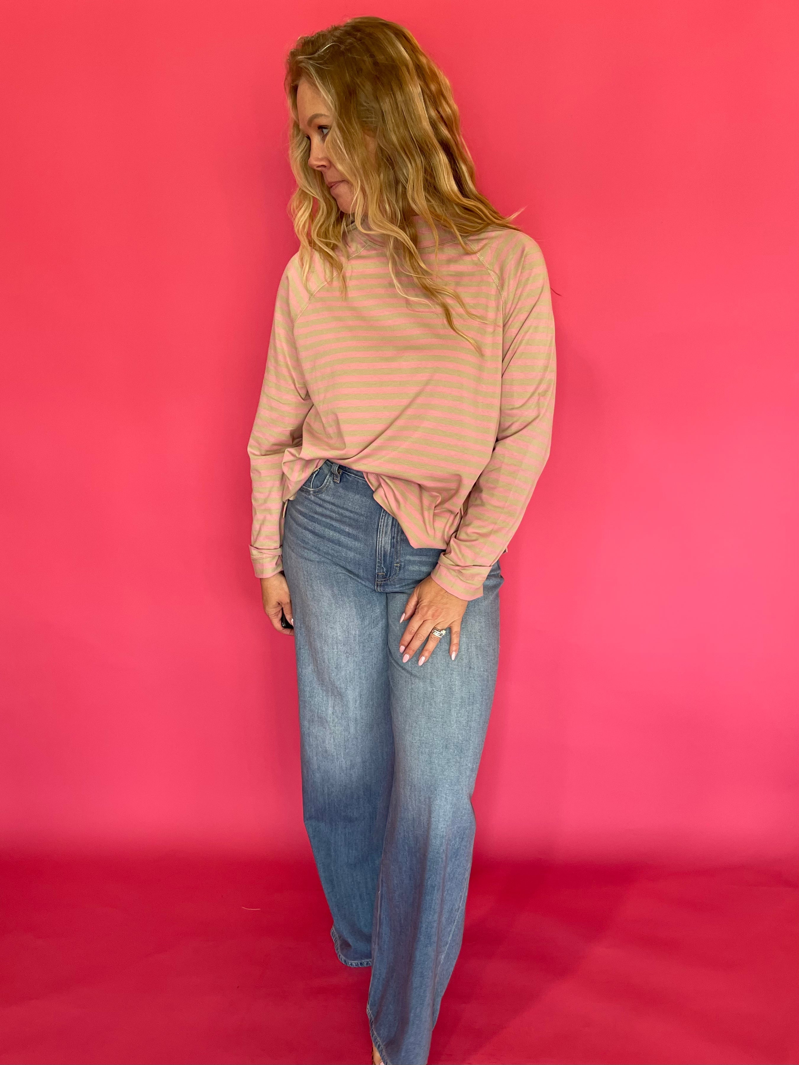 Detail of the ribbed cuff and cropped hem on the striped oversized mock neck long sleeve tee