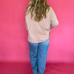 Full length view of the oversized striped mock neck tee worn over straight leg denim