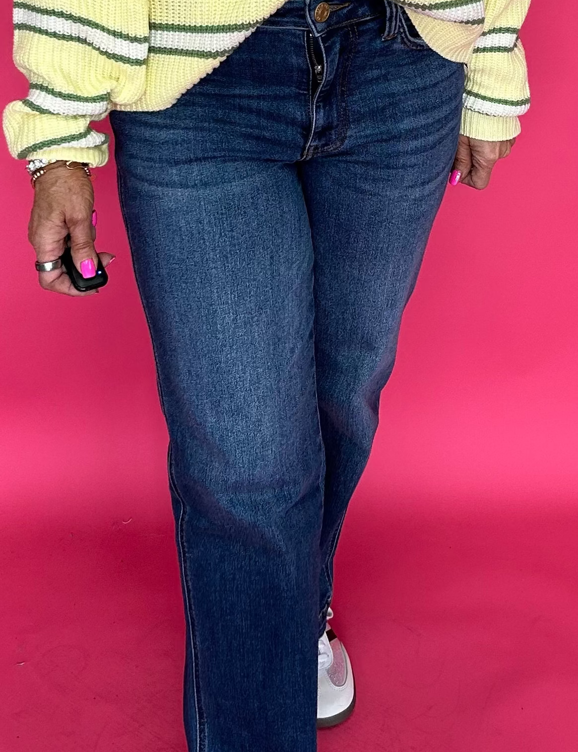 Woman wearing high rise straight leg jeans with a clean hem and a tucked in tee for everyday wear