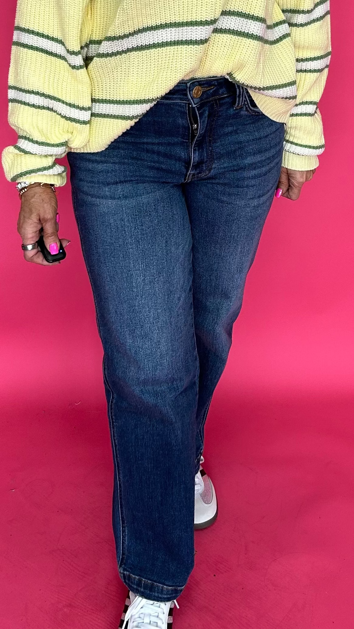 Woman wearing high rise straight leg jeans with a clean hem and a tucked in tee for everyday wear