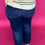 Detail of the high rise waistband and button front closure on the straight leg stretch denim jeans