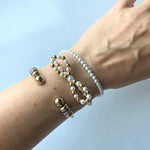 Close-up of the faux pearl beads and the elastic band on the petite pearl stretch bracelet