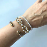 Close-up of the faux pearl beads and the elastic band on the petite pearl stretch bracelet