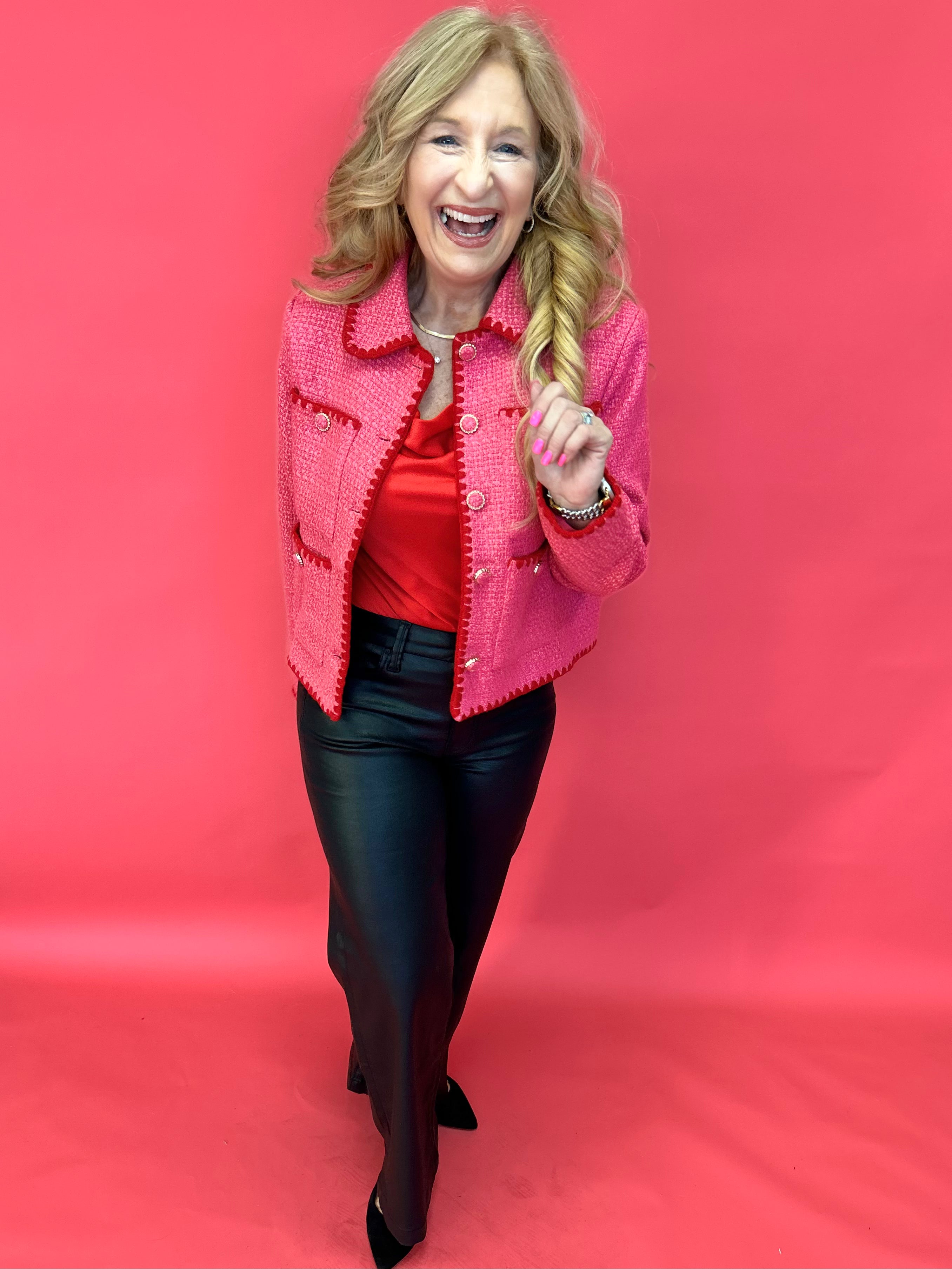 Back view of the pink embroidered tweed jacket showing its tailored long sleeve silhouette