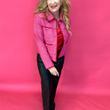 Woman styling the pink tweed jacket over denim and a simple tank with neutral heels