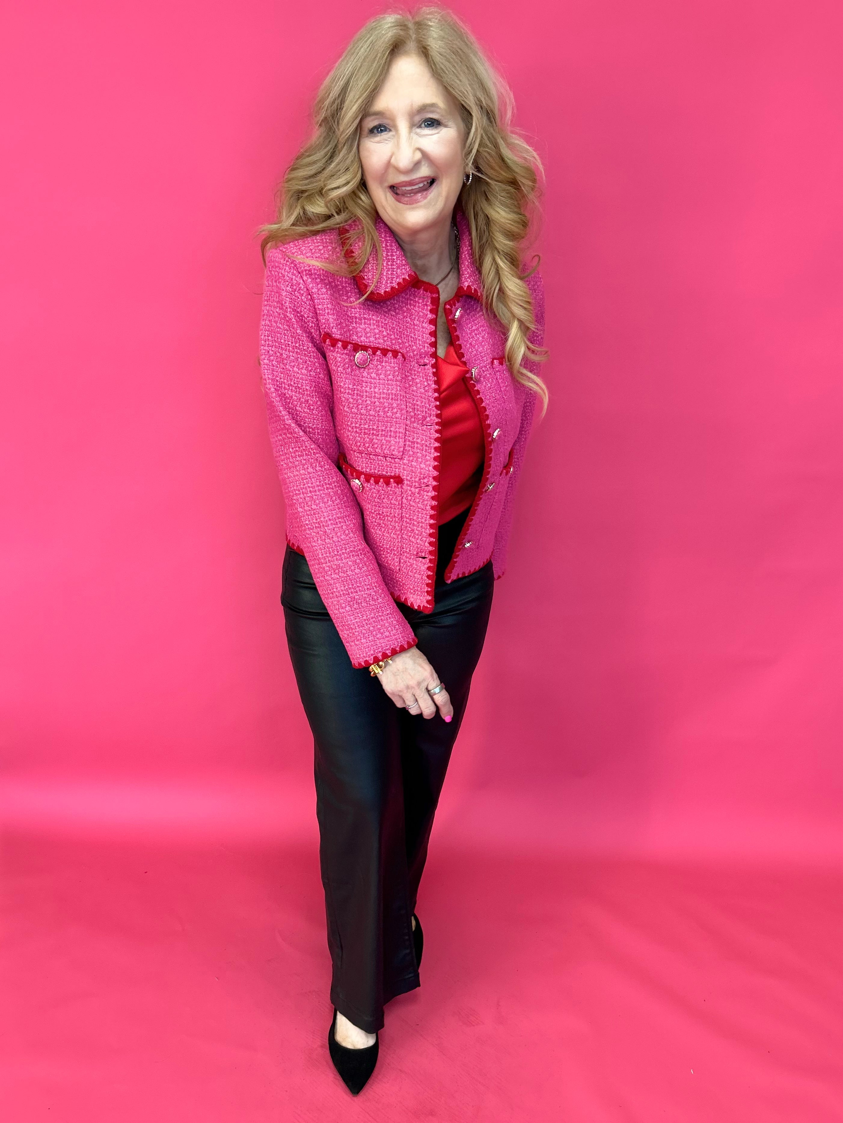 Woman styling the pink tweed jacket over denim and a simple tank with neutral heels