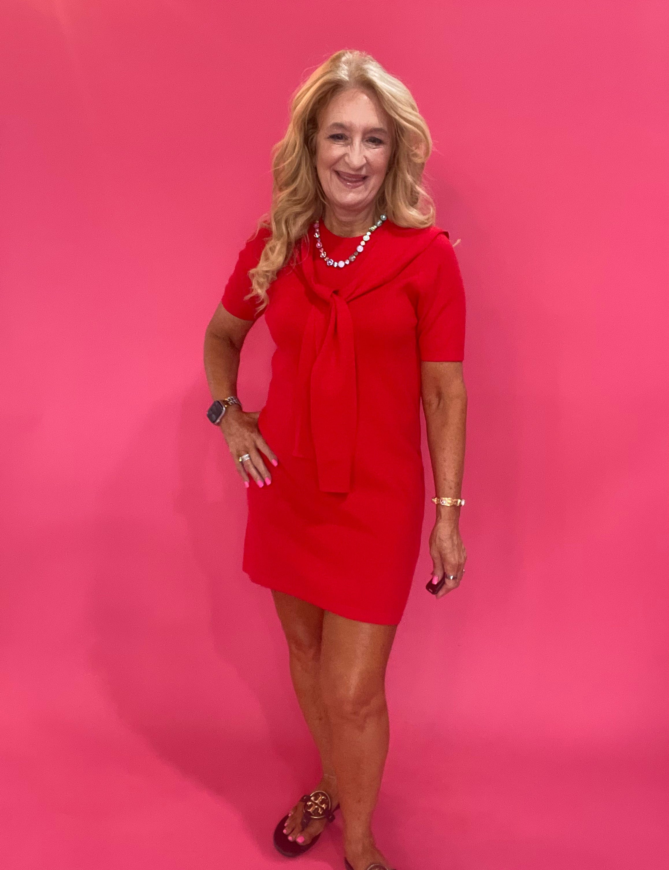 Back view of the red tie neck dress showing the easy flowy fit