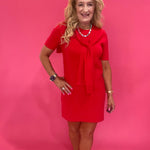 Side view showing the drape and length of the red short sleeve dress