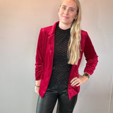 Back view of the red velvet blazer showing the tailored silhouette and smooth lining