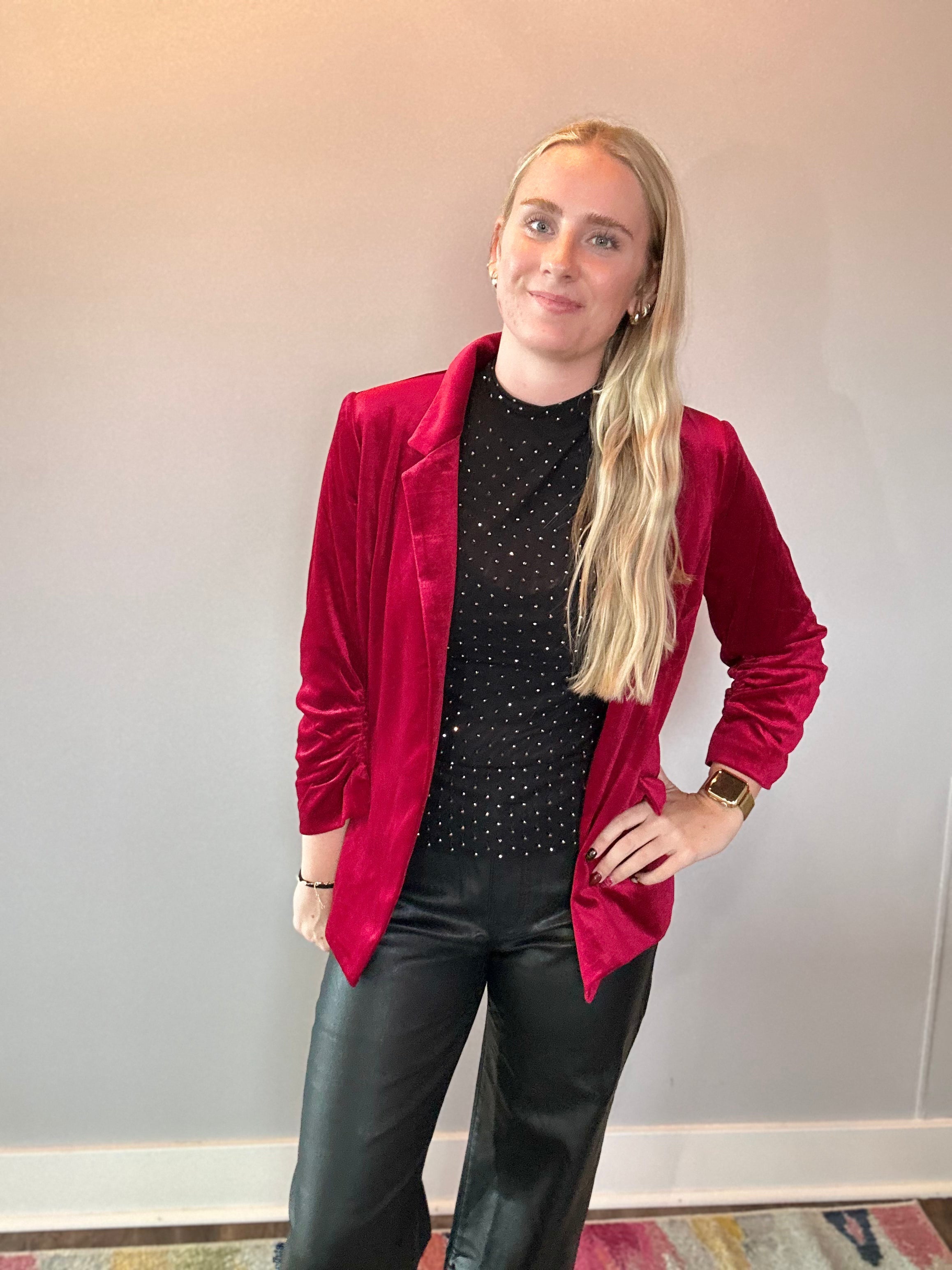 Back view of the red velvet blazer showing the tailored silhouette and smooth lining