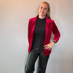 Flat lay of the red stretch velvet blazer showing the notched lapels and button front closure