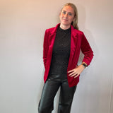Flat lay of the red stretch velvet blazer showing the notched lapels and button front closure