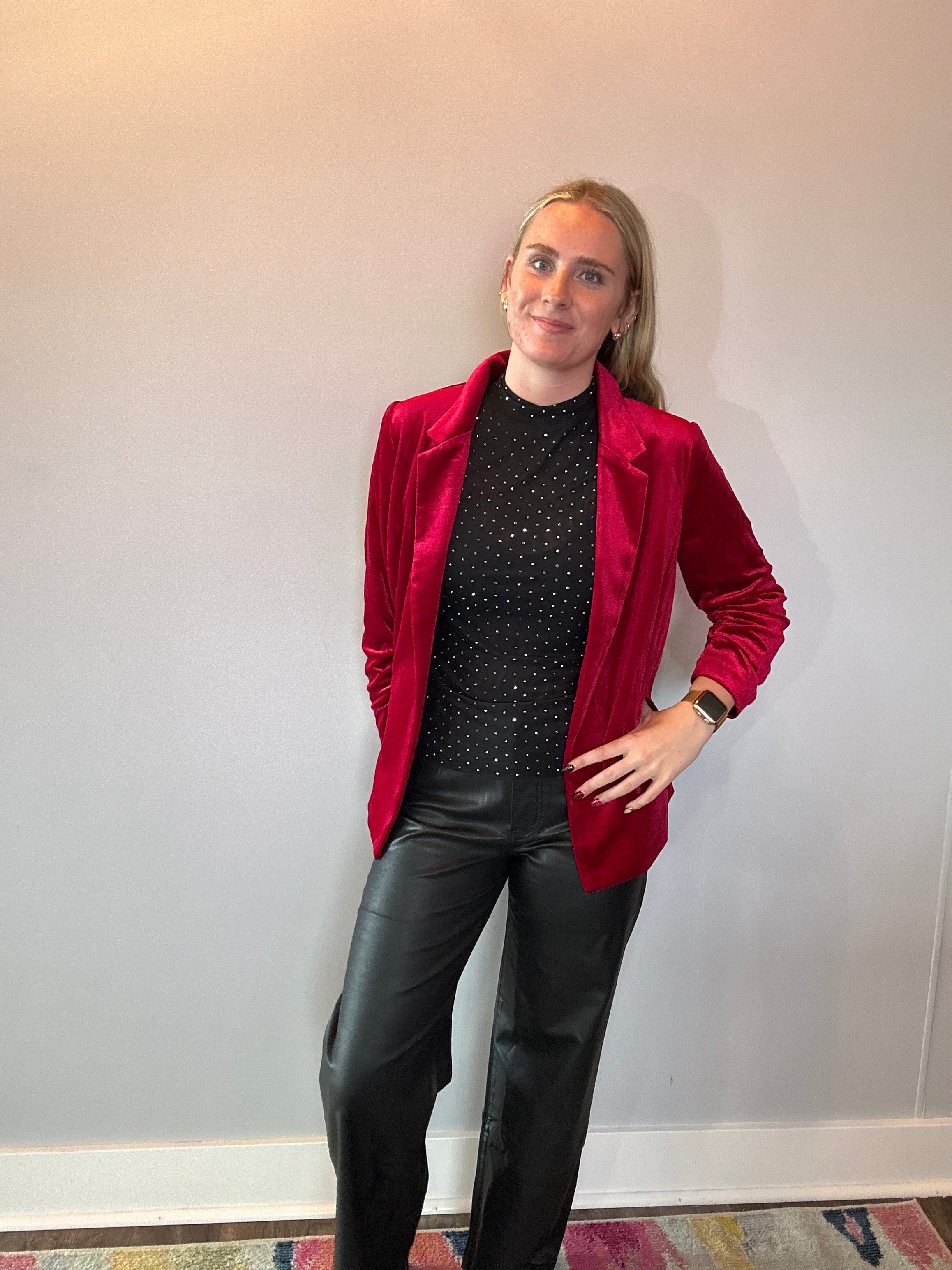 Flat lay of the red stretch velvet blazer showing the notched lapels and button front closure
