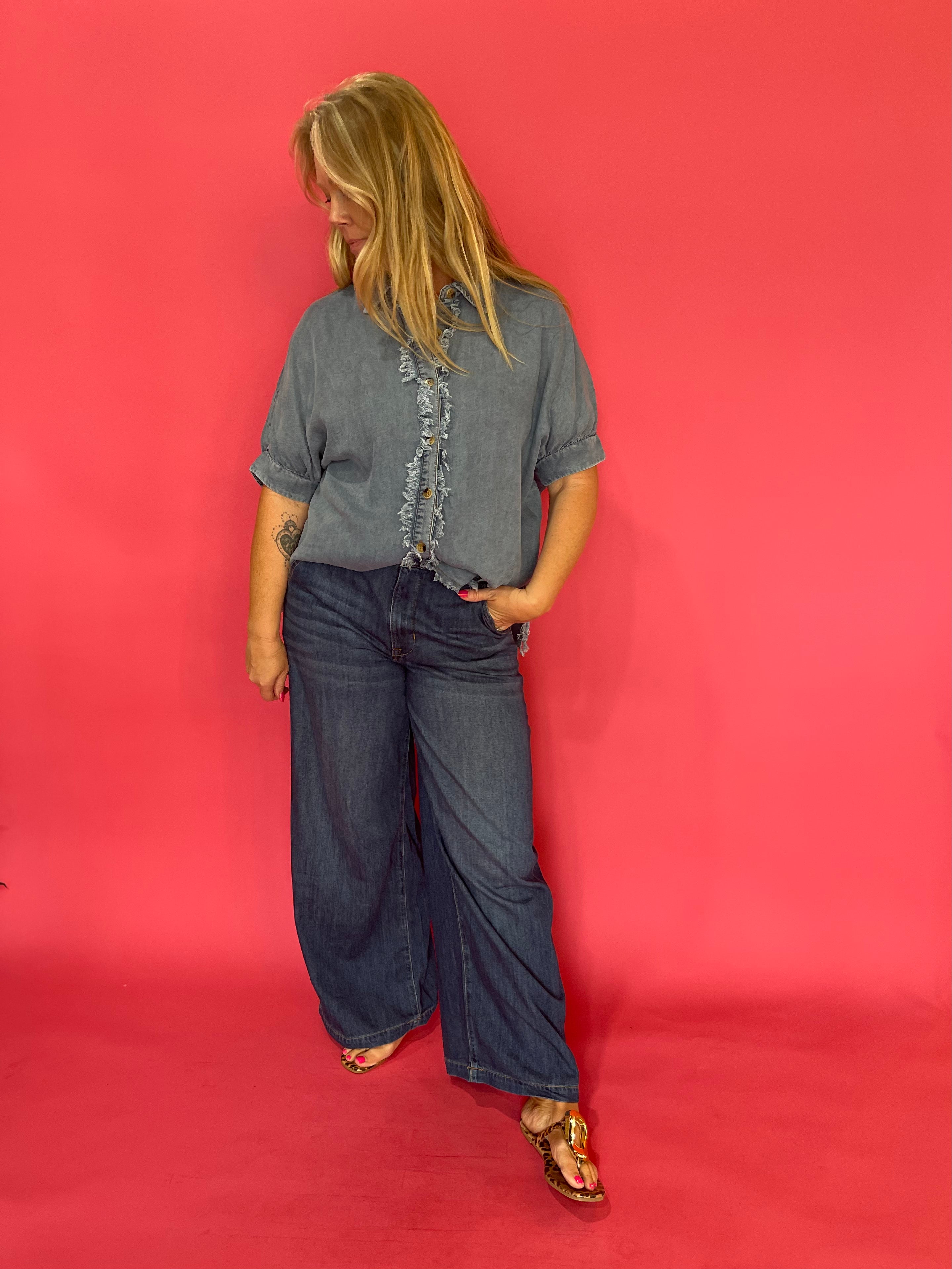 Back view of the mineral wash denim button-up showing its easy relaxed fit through the body