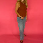 Close-up of the soft stretchy ribbed sweater knit texture on the rust sleeveless tank