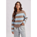 Woman wearing a brown and sky blue striped boatneck sweater with a relaxed fit and rolled neckline