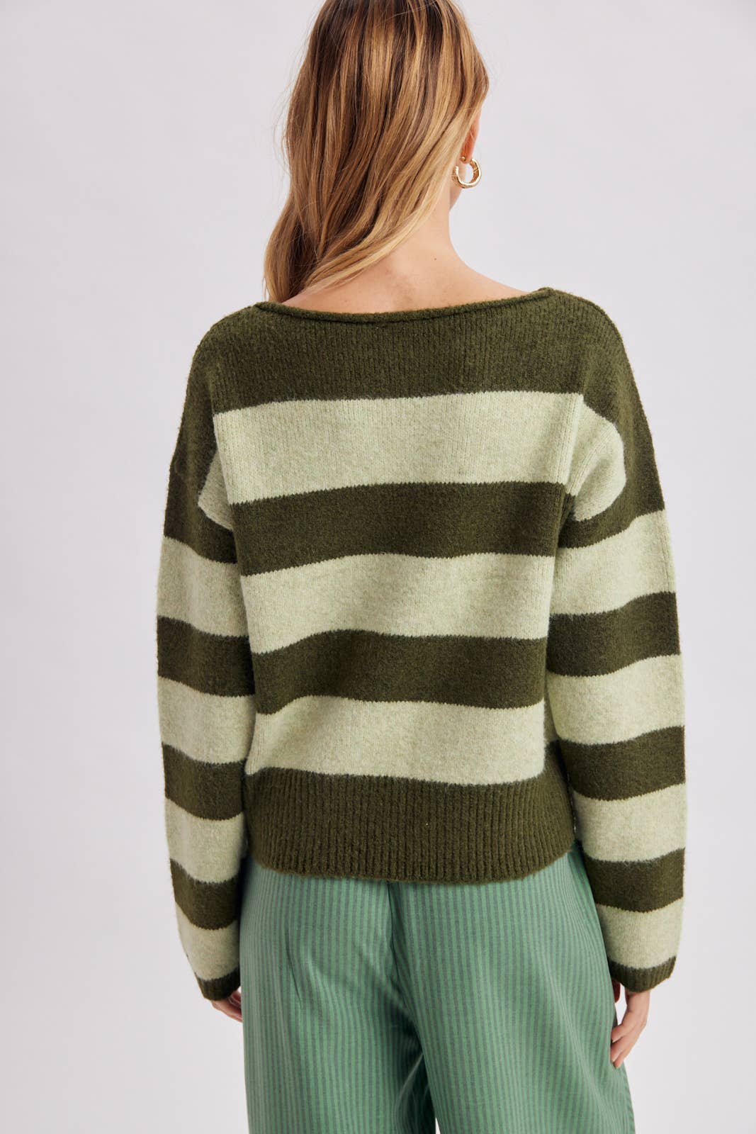 Detail of the soft knit texture and stripe repeat on the brown and sky blue boatneck sweater