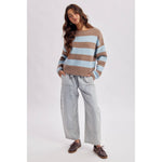 Back view of the brown and sky striped boatneck sweater showing the relaxed knit shoulders and hem