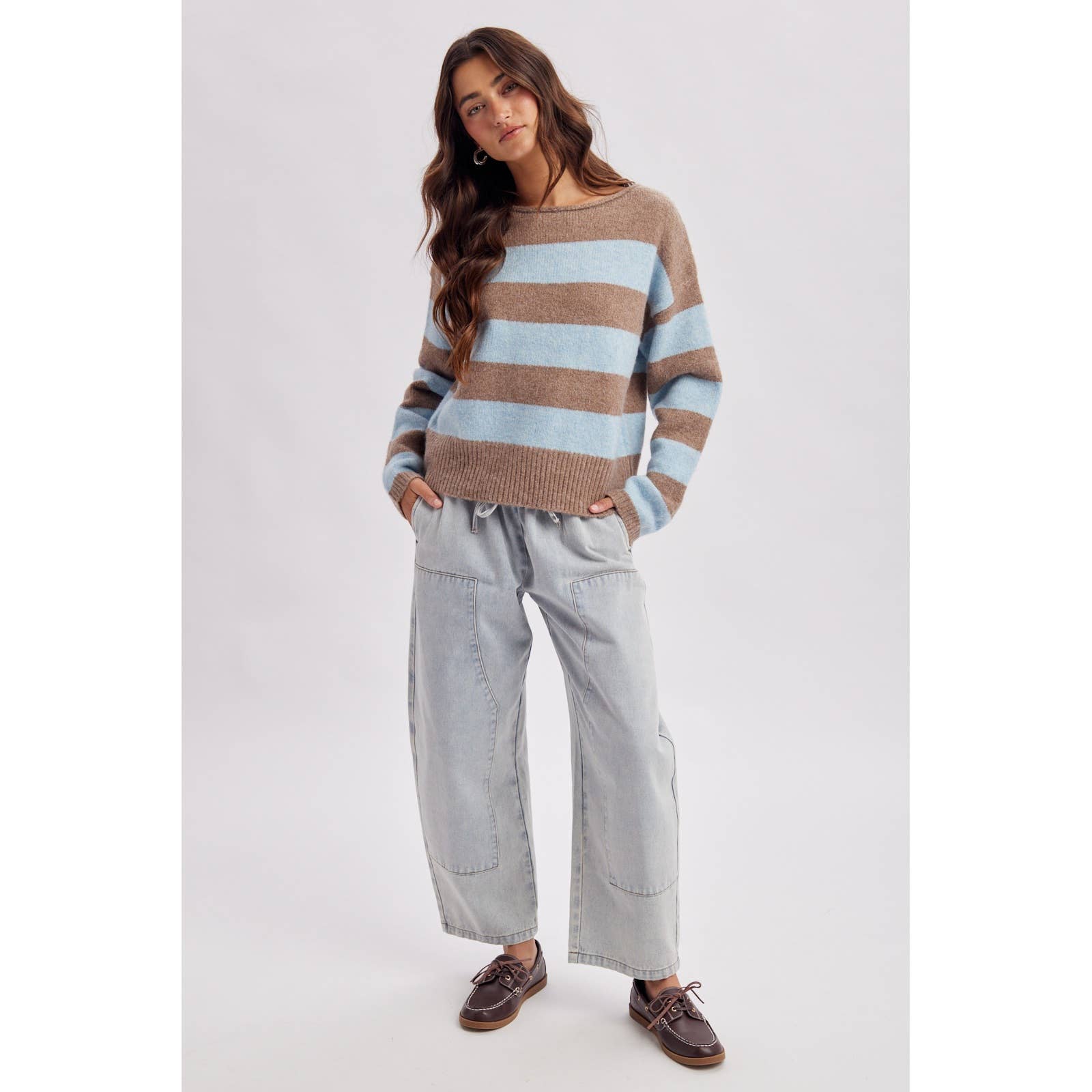 Back view of the brown and sky striped boatneck sweater showing the relaxed knit shoulders and hem