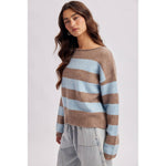 Close-up of the rolled boat neckline on the brown and sky blue striped soft knit sweater