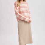 Side view of the striped boatneck sweater in brown and sky blue worn with a relaxed drape