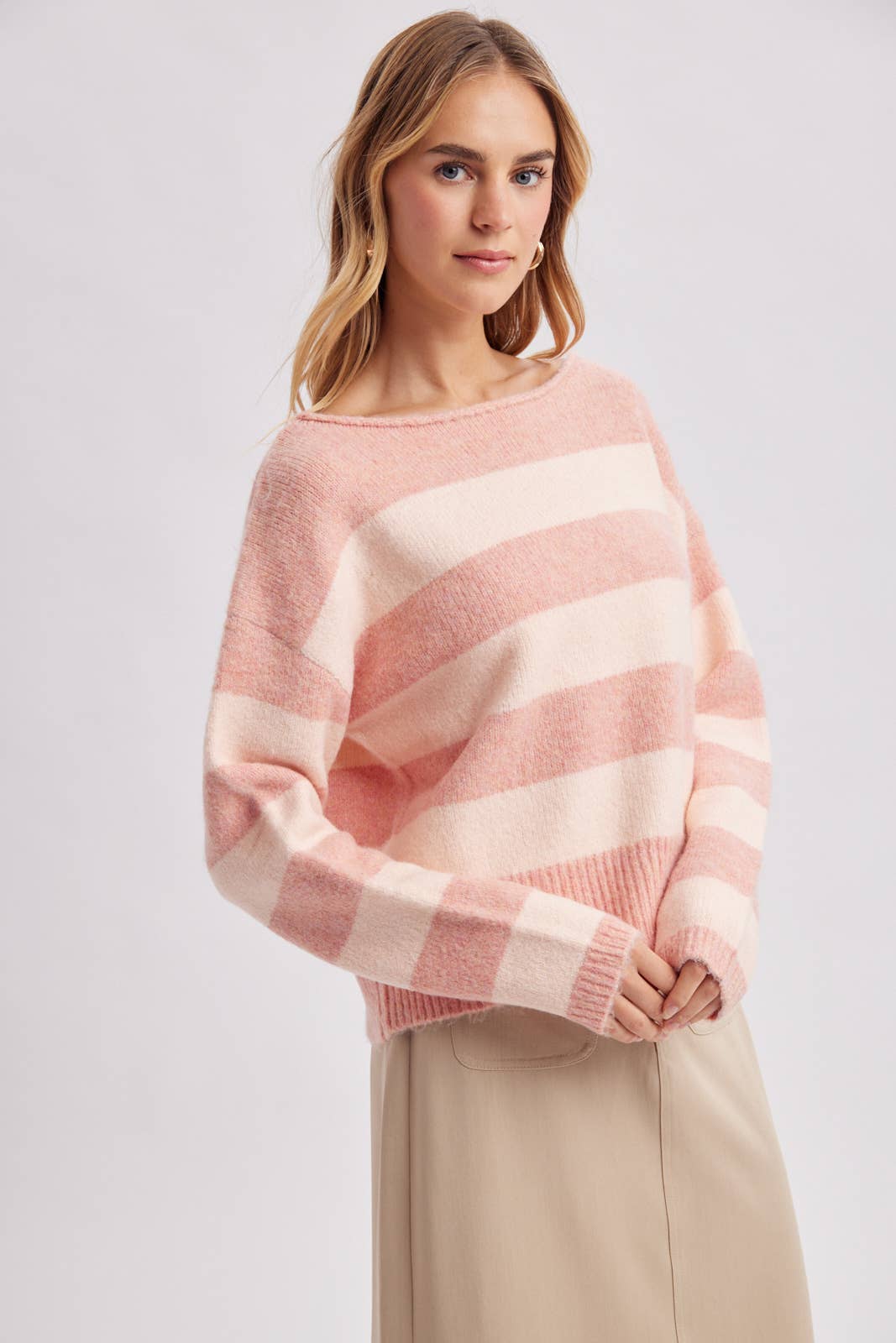 Close-up of the horizontal stripe pattern in brown and sky blue on the cozy knit sweater