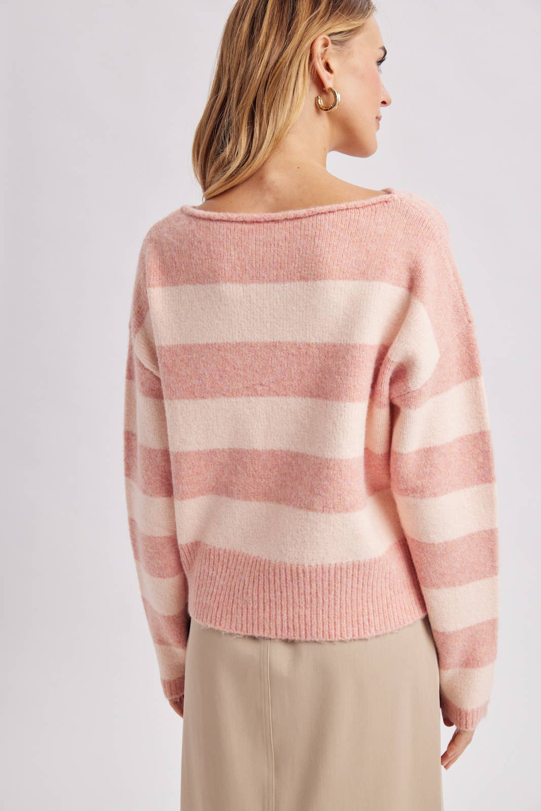 Three quarter view of the brown and sky striped boatneck sweater styled for a casual weekend
