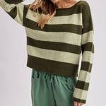Front view of the relaxed fit striped sweater in brown and sky blue worn untucked over pants