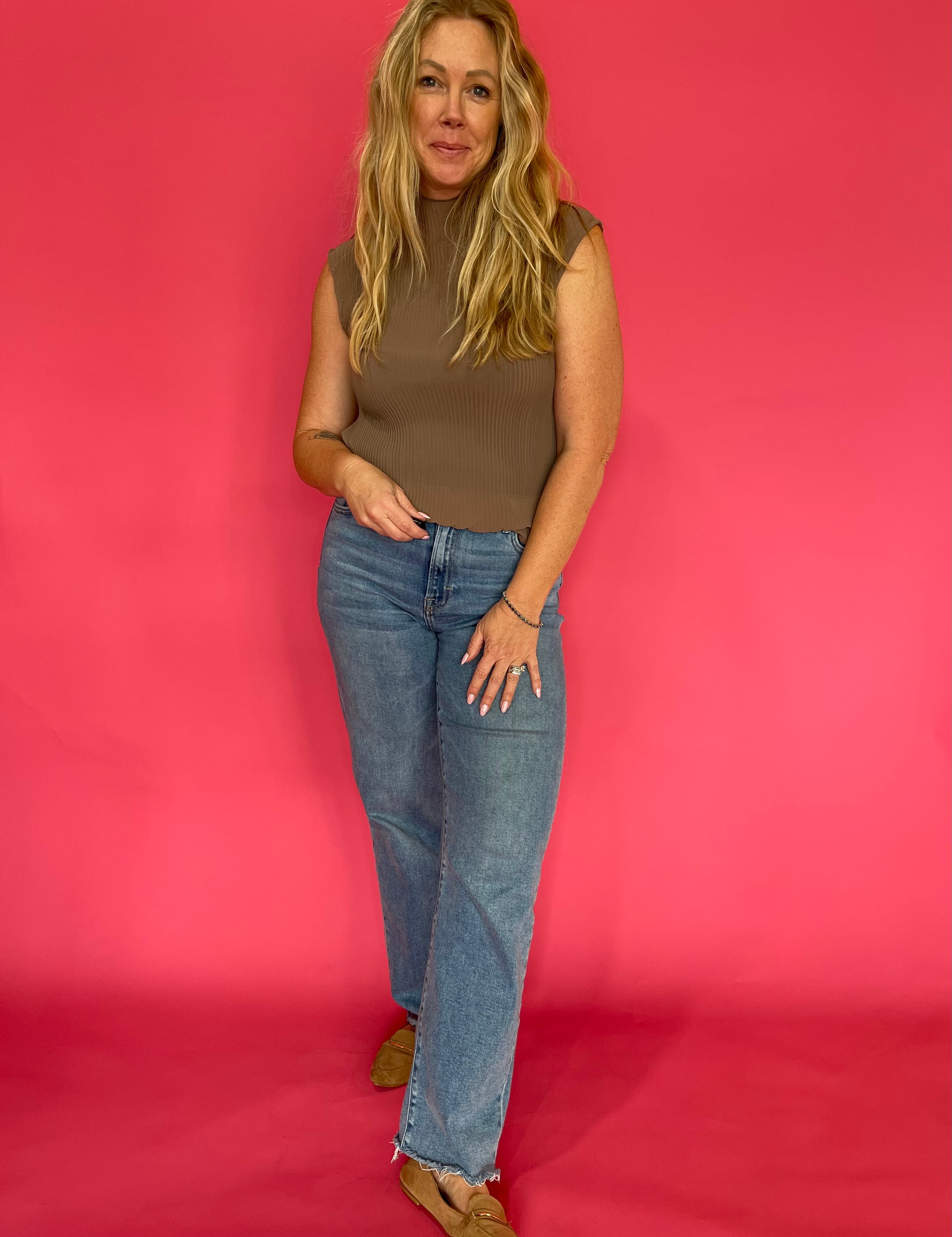 Back view of the mocha plisse blouse showing the mock neckline and relaxed drape