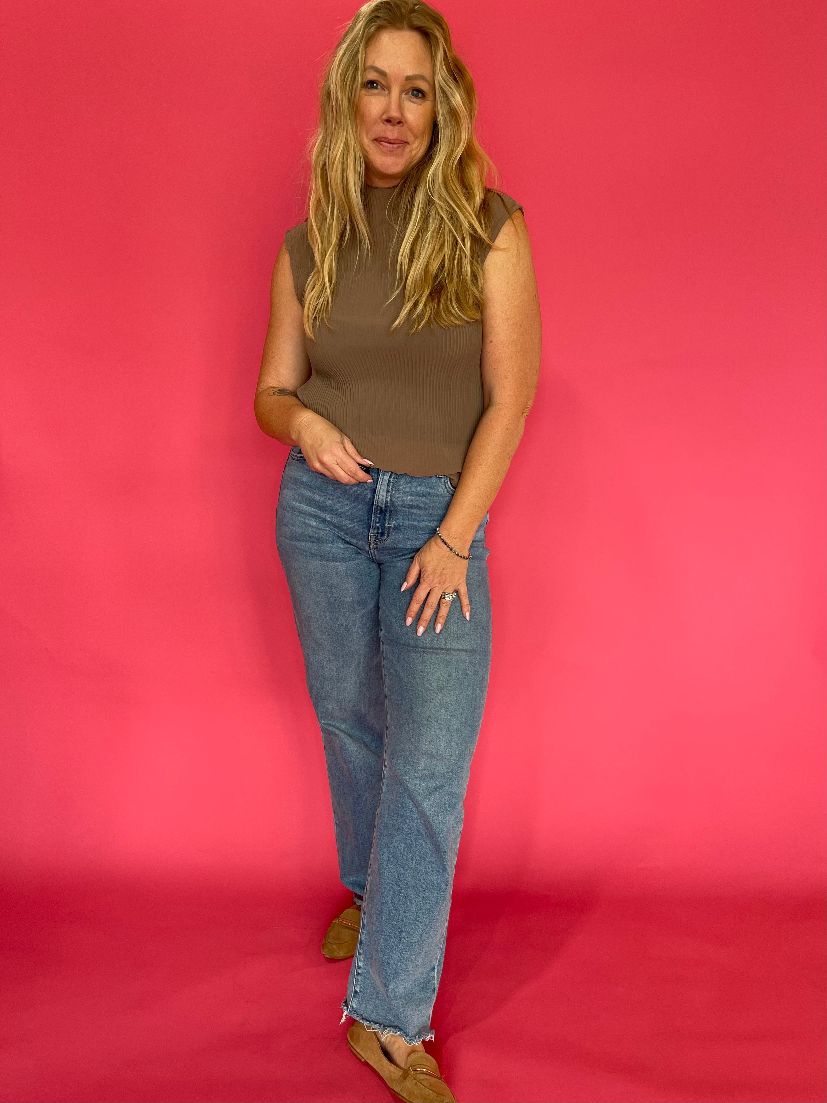 Back view of the mocha plisse blouse showing the mock neckline and relaxed drape