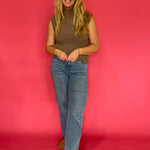 Mocha sheer plisse blouse tucked into tailored trousers for a polished office look