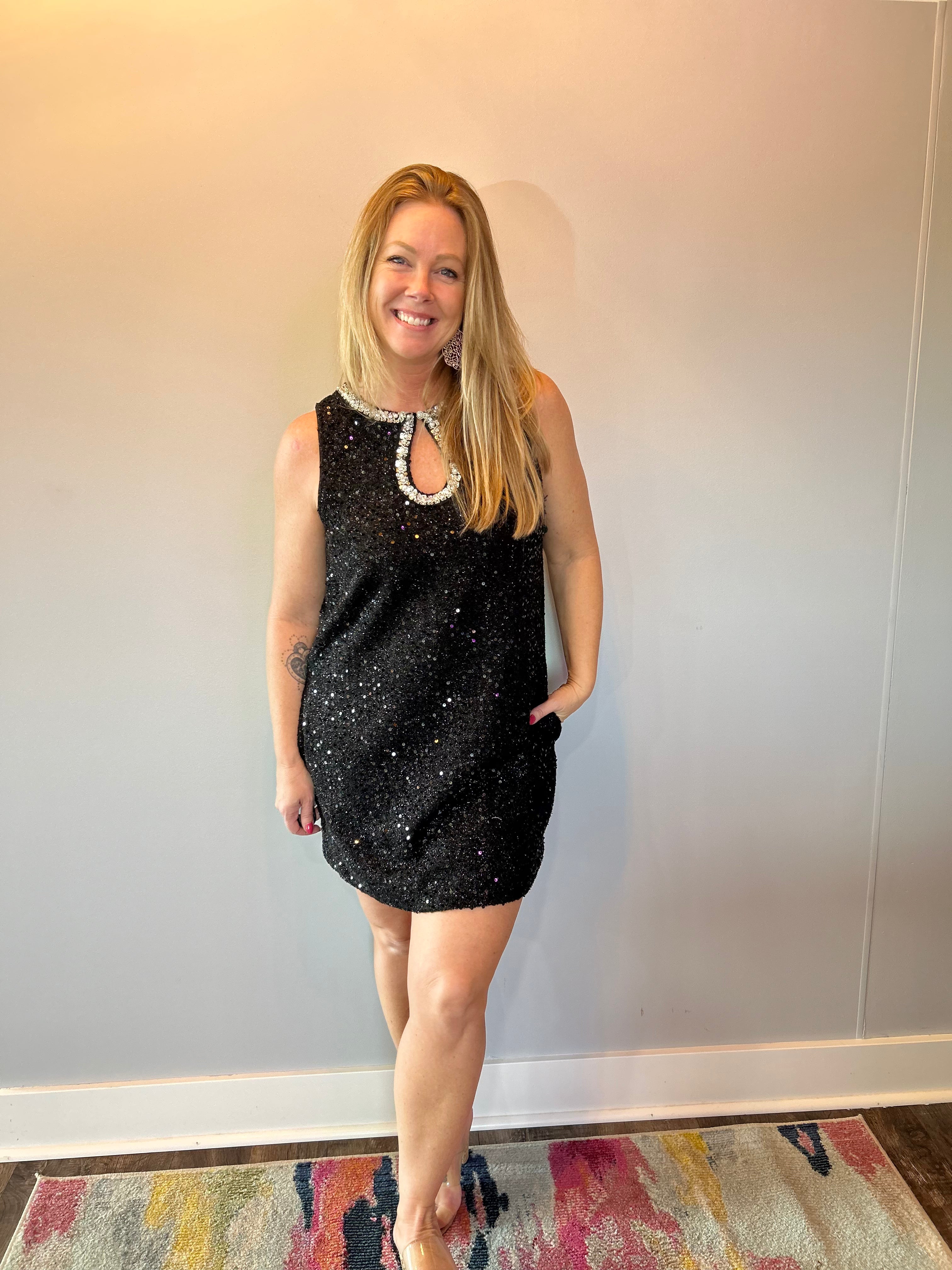 Close-up of the beaded neckline and front keyhole on the sequin dress