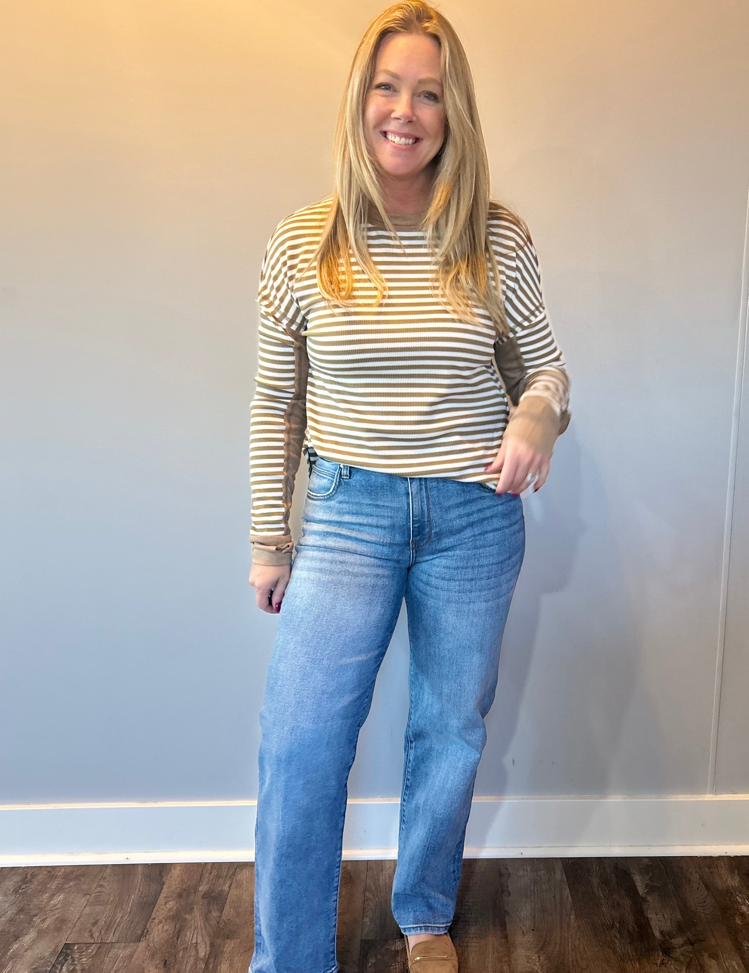 Back view of the medium wash straight jeans showing five pocket styling and a relaxed leg