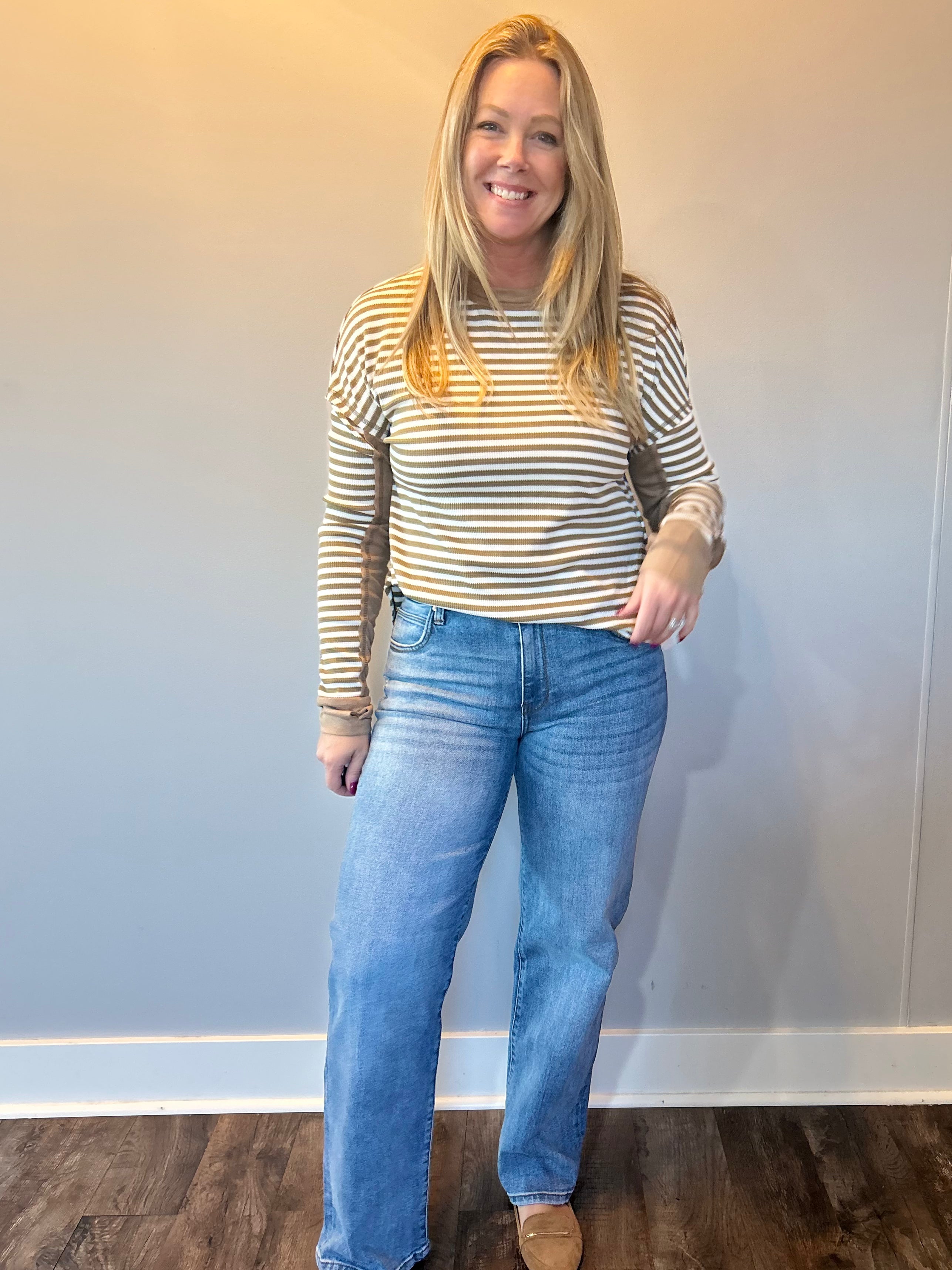 Back view of the medium wash straight jeans showing five pocket styling and a relaxed leg