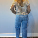 Side view showing the 31 inch inseam and 18 and a half inch leg opening on the straight jeans