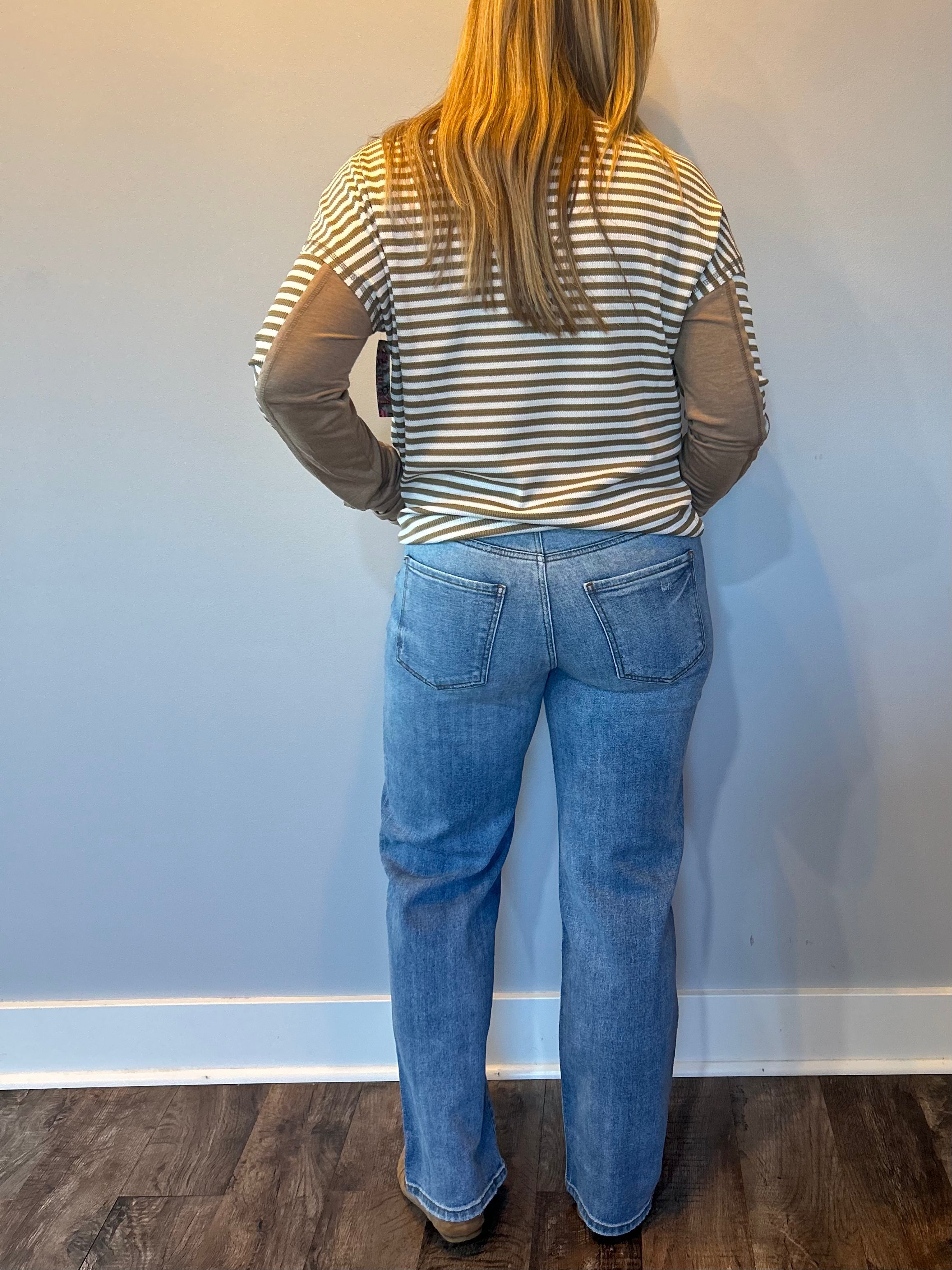 Side view showing the 31 inch inseam and 18 and a half inch leg opening on the straight jeans