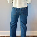 Close-up of the frayed raw hem edge on the cotton lyocell blend straight leg jeans at the ankle