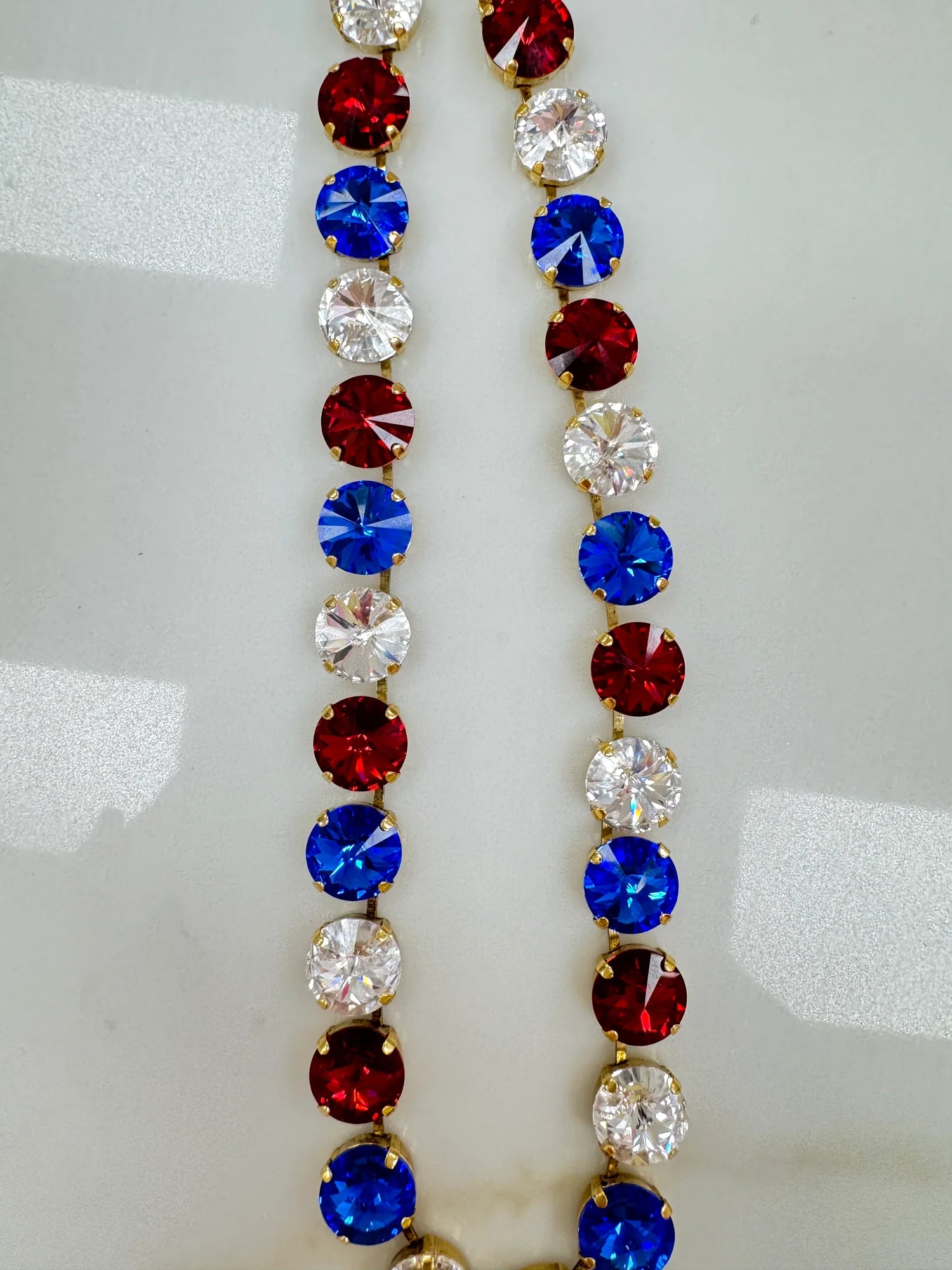 Close-up of the crystal detail and antique gold plated links on the Sofia necklace in 4th of July mix