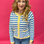 Woman wearing a wavy stripe contrast knit sweater with long sleeves and a drop shoulder