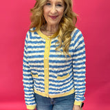 Woman wearing a wavy stripe contrast knit sweater with long sleeves and a drop shoulder