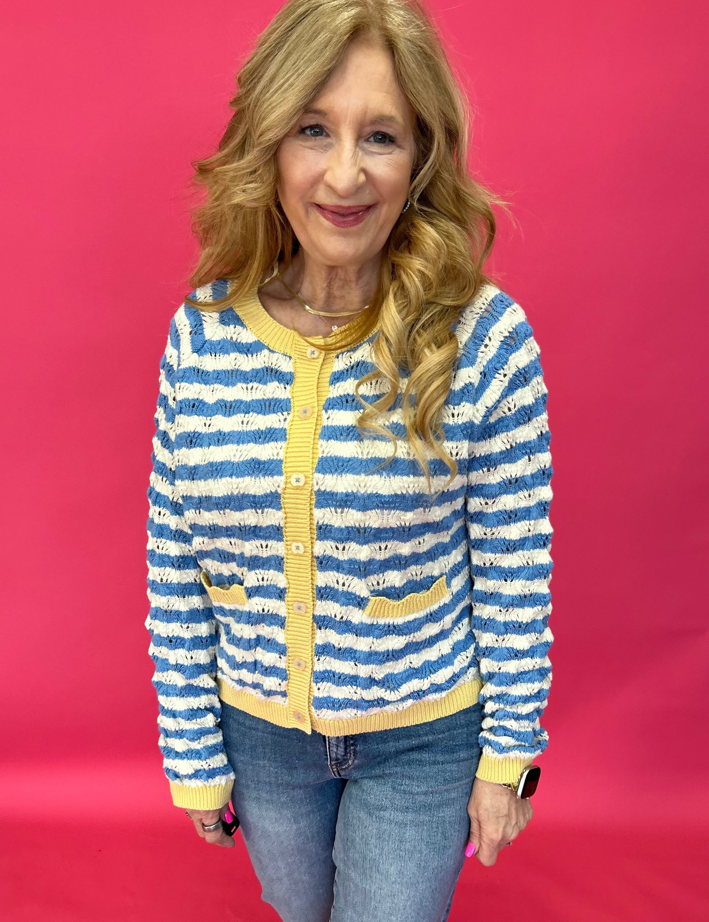Woman wearing a wavy stripe contrast knit sweater with long sleeves and a drop shoulder