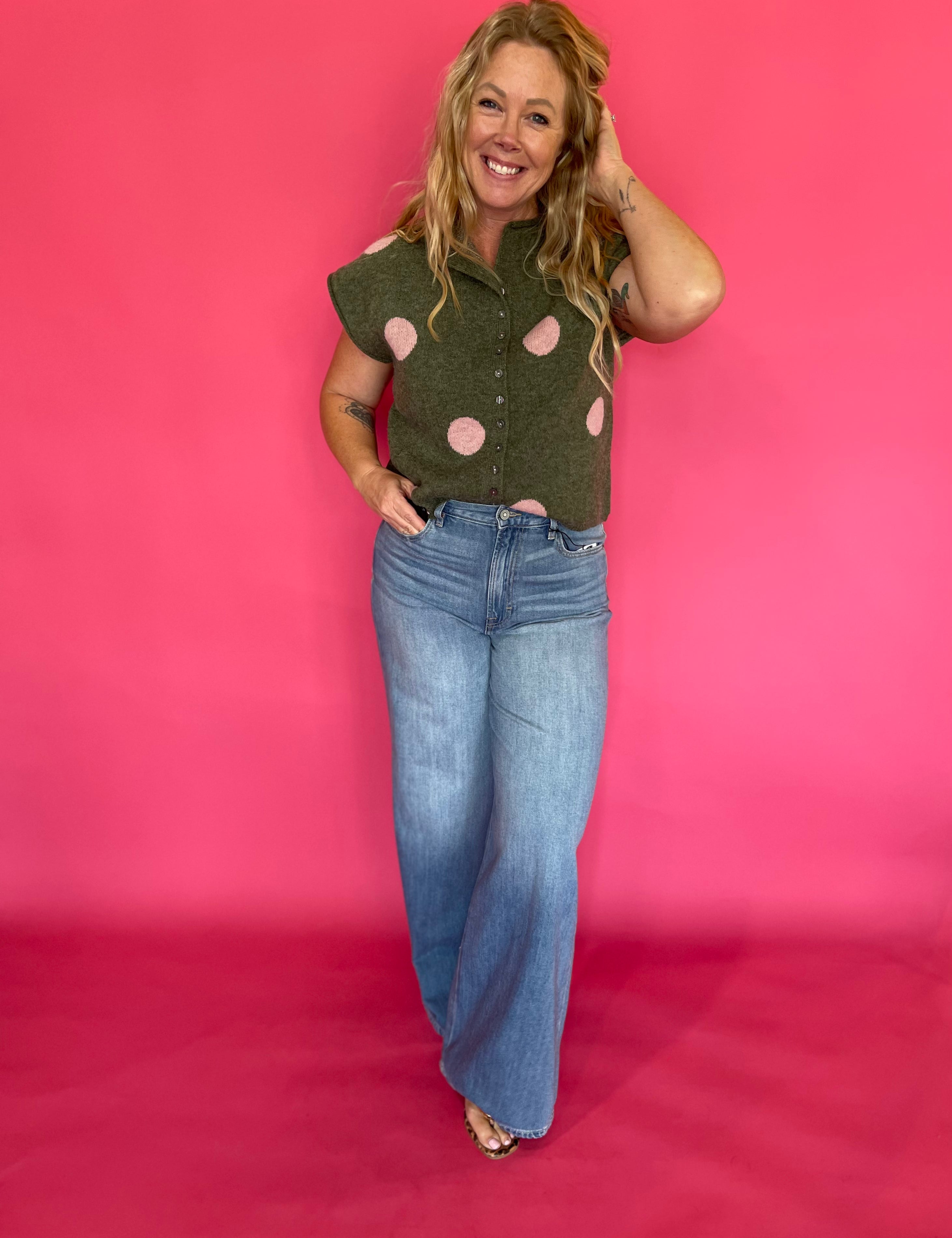 Back view of the cropped olive polka dot sweater top showing the relaxed lightweight knit body