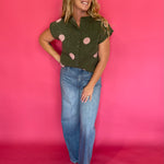 Flat lay of the olive green blush polka dot sweater top with the front buttons fastened