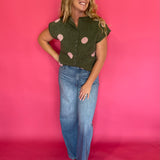 Flat lay of the olive green blush polka dot sweater top with the front buttons fastened