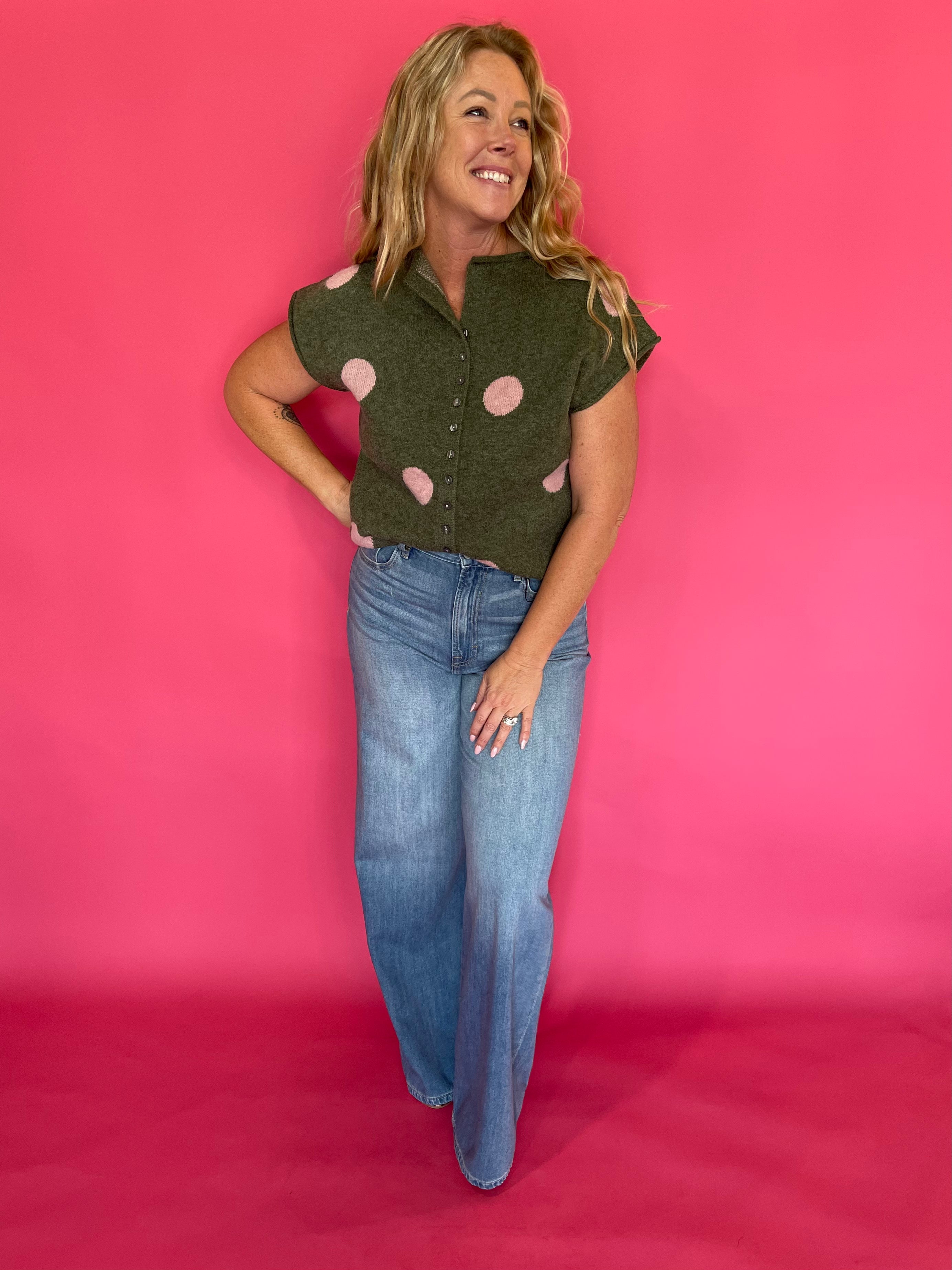 Flat lay of the olive green blush polka dot sweater top with the front buttons fastened
