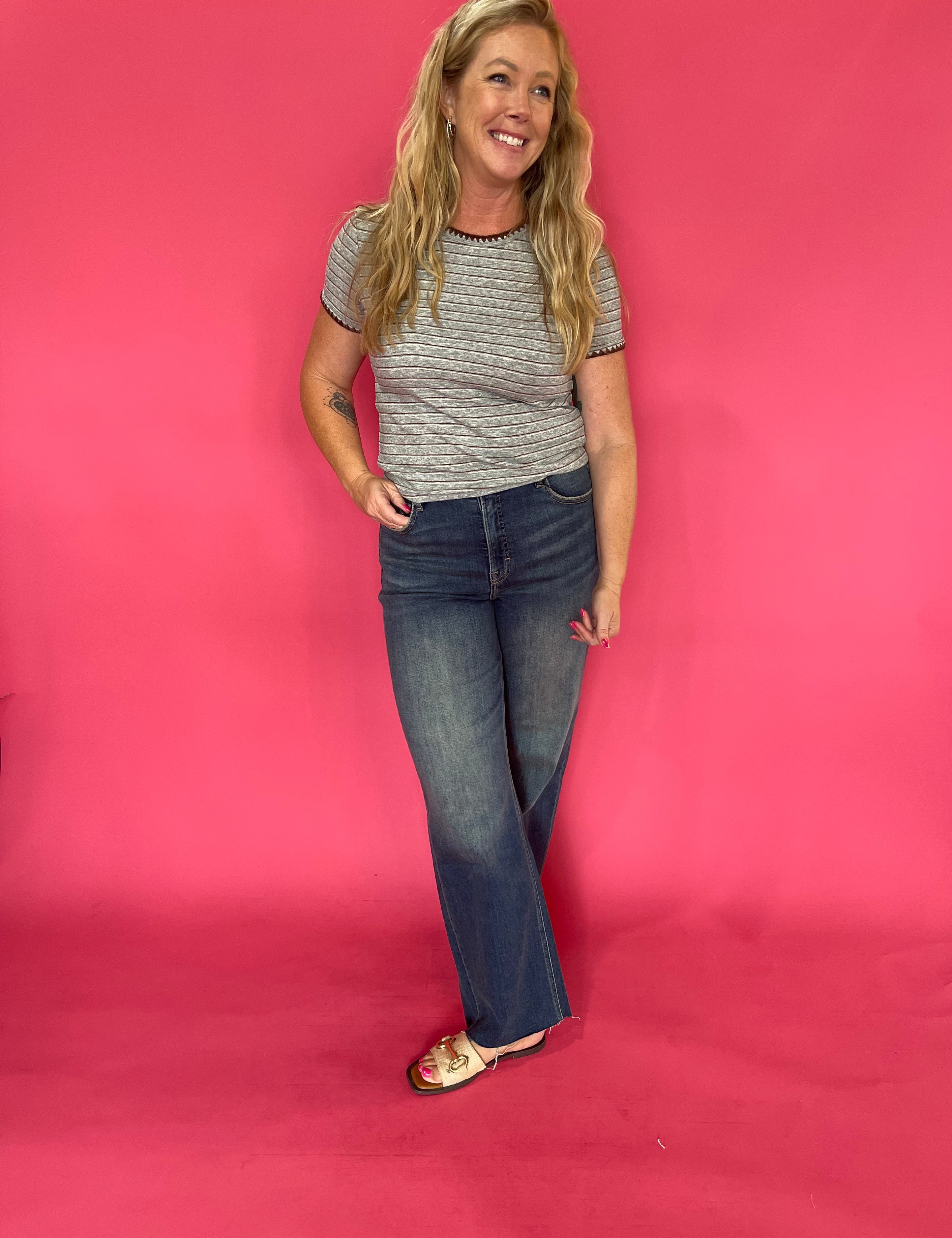 Back view of the grey striped baby tee showing the close fitted body and short sleeve cut