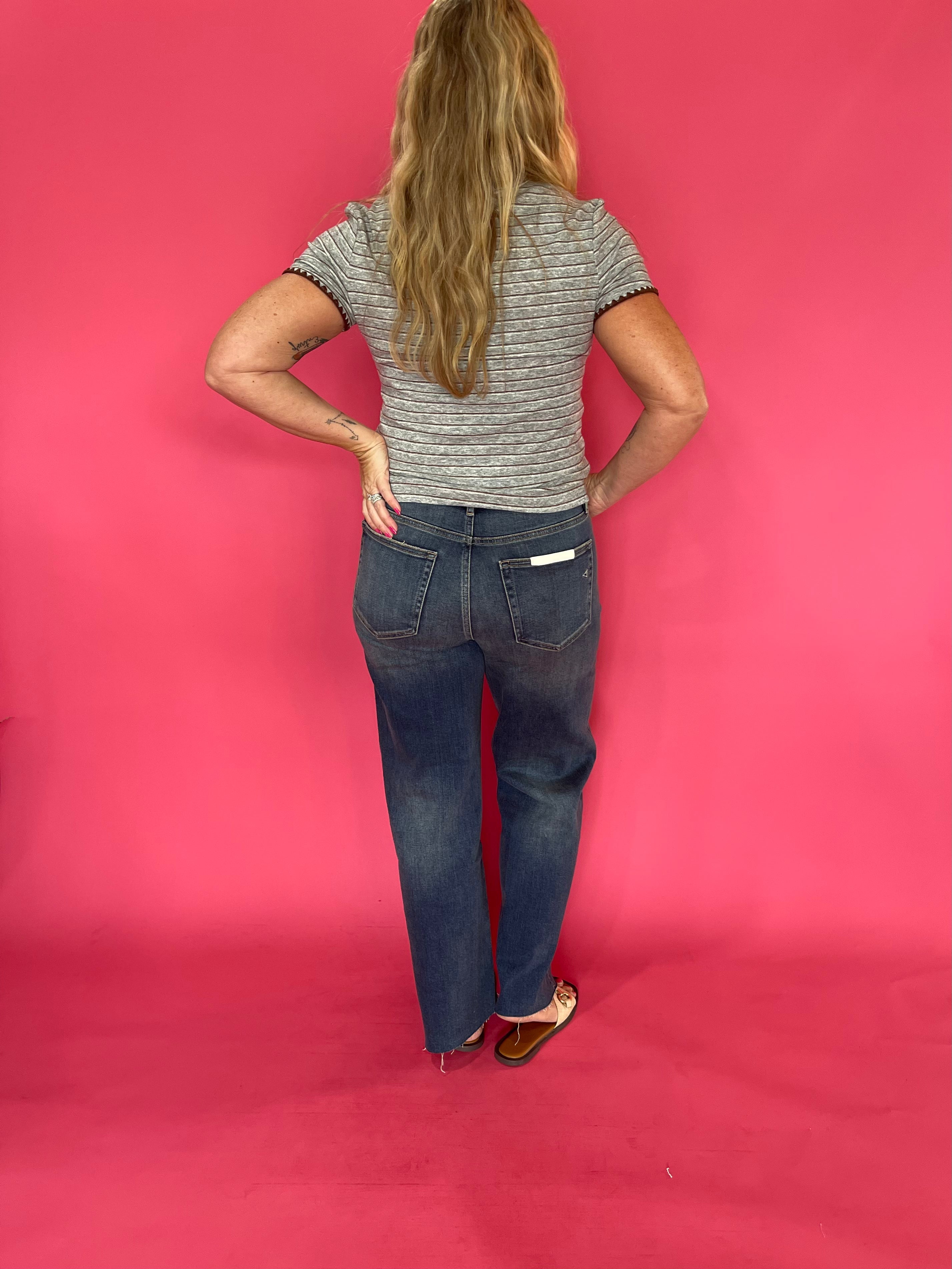 Flat lay of the grey striped baby tee showing the contrast stitch detail across the front